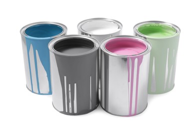 Photo of Cans of colorful paints isolated on white