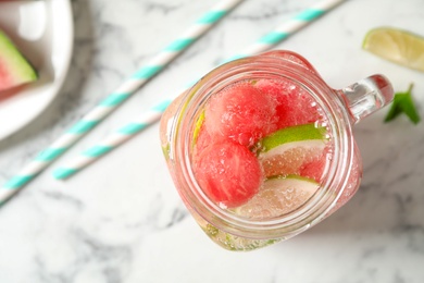 Photo of Tasty refreshing watermelon drink on marble table, top view