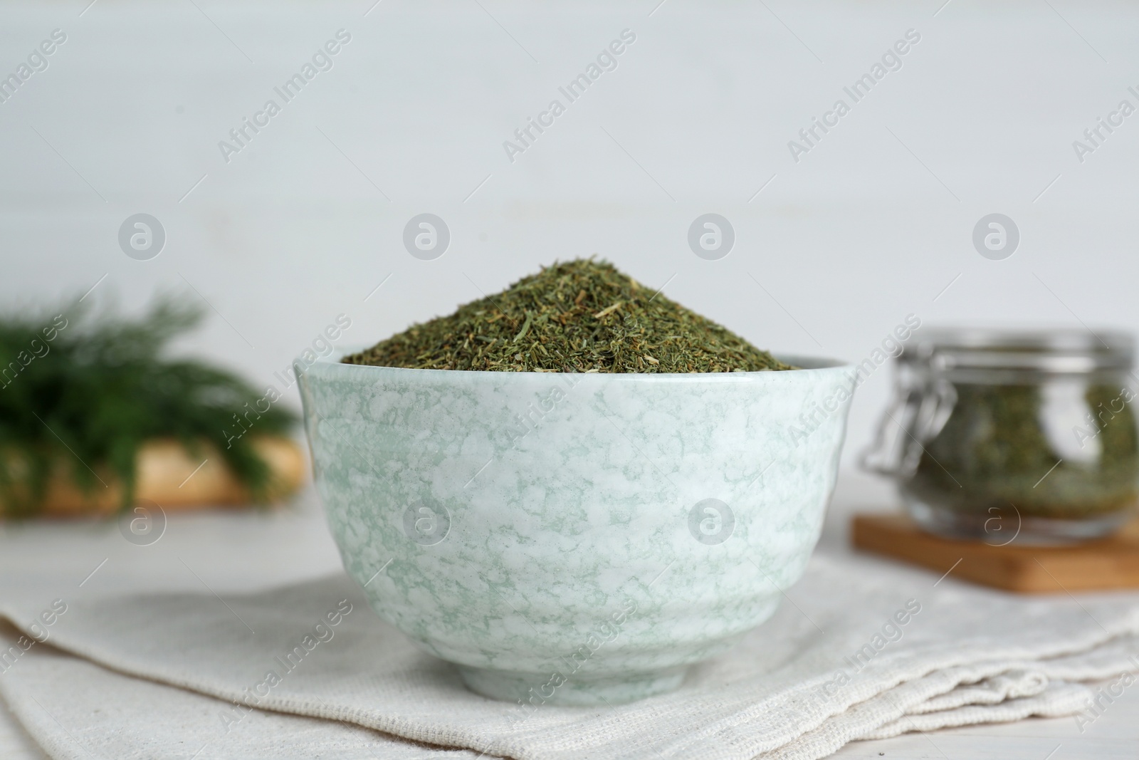 Photo of Dried dill in bowl on table, closeup