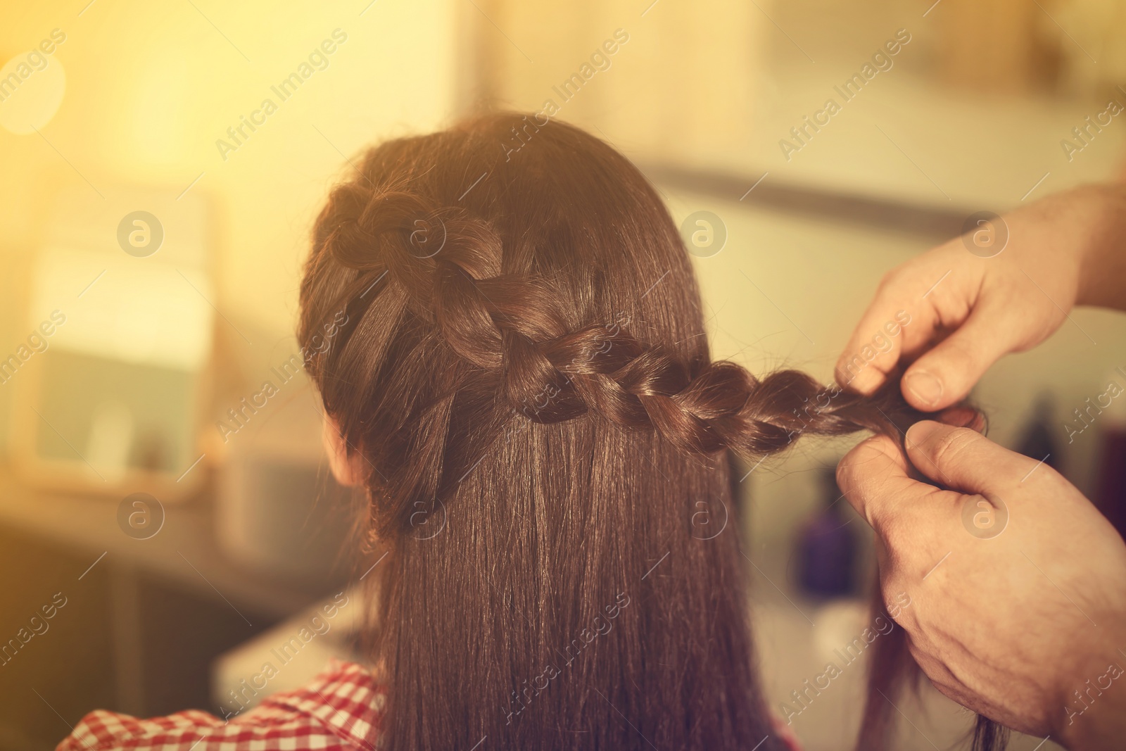 Image of Professional hairdresser working with client in beauty salon, closeup