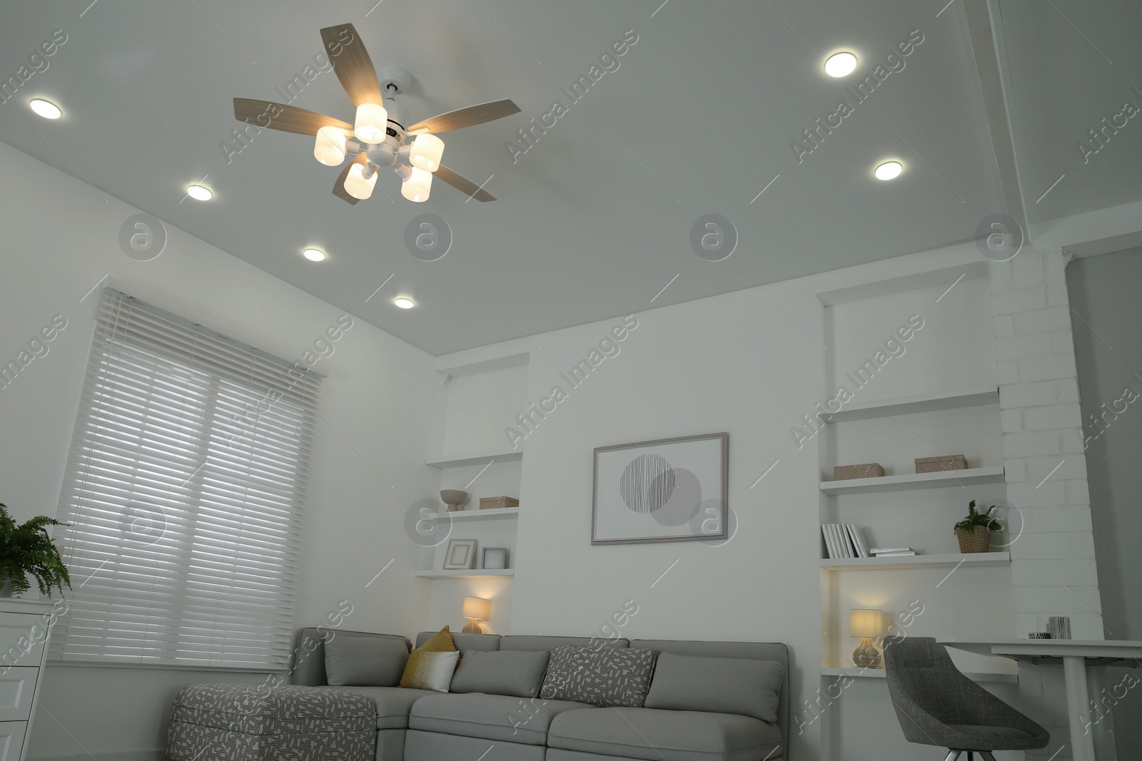 Photo of Ceiling fan, furniture and accessories in stylish living room, low angle view