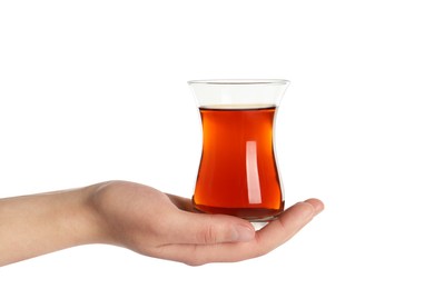 Woman holding glass of traditional Turkish tea on white background, closeup