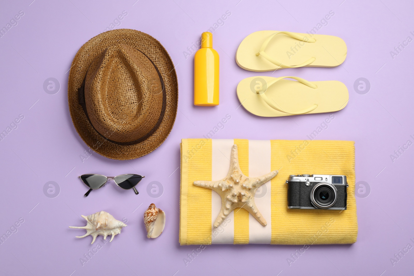Photo of Flat lay composition with beach objects on violet background