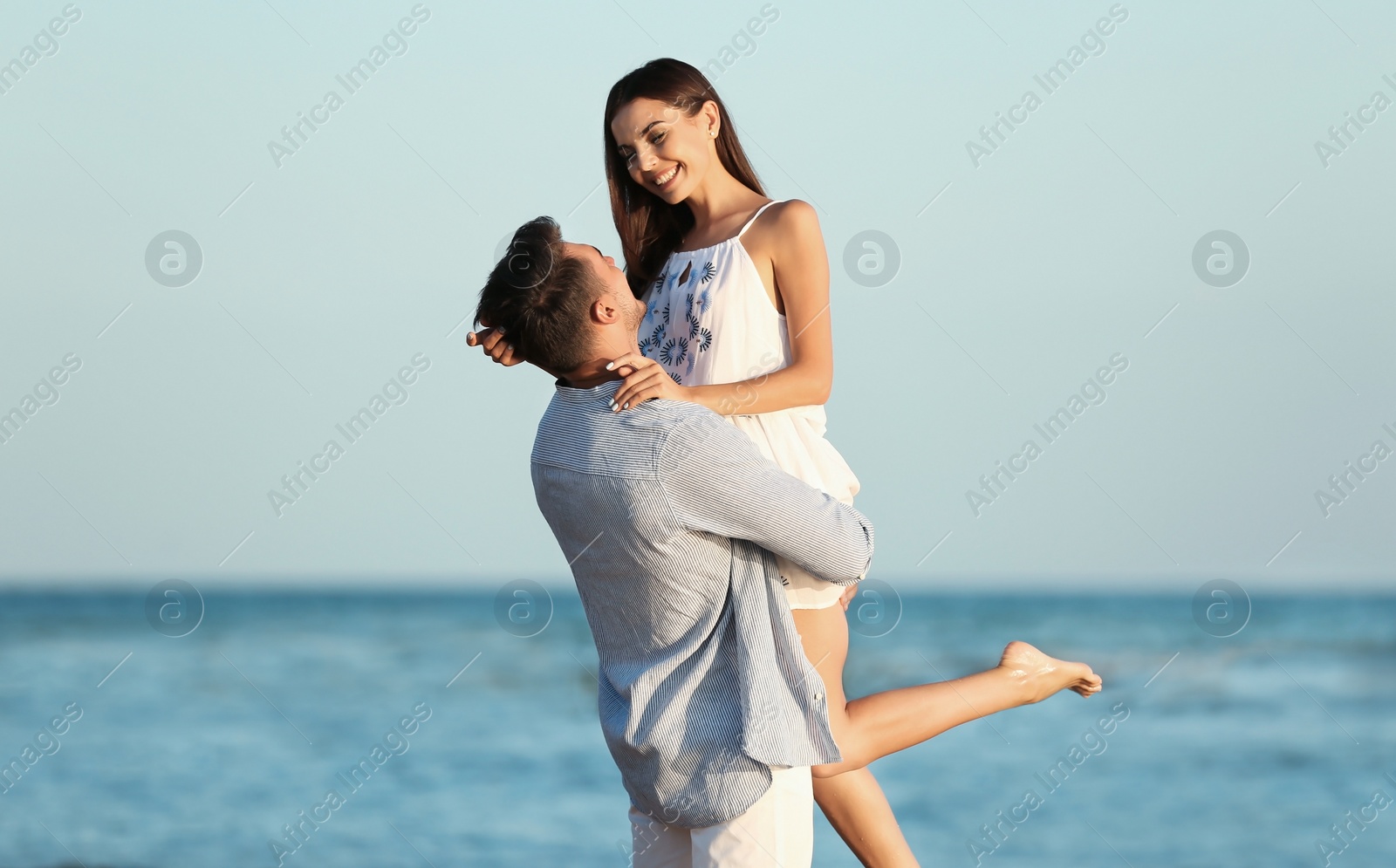 Photo of Happy young couple having fun at beach on sunny day