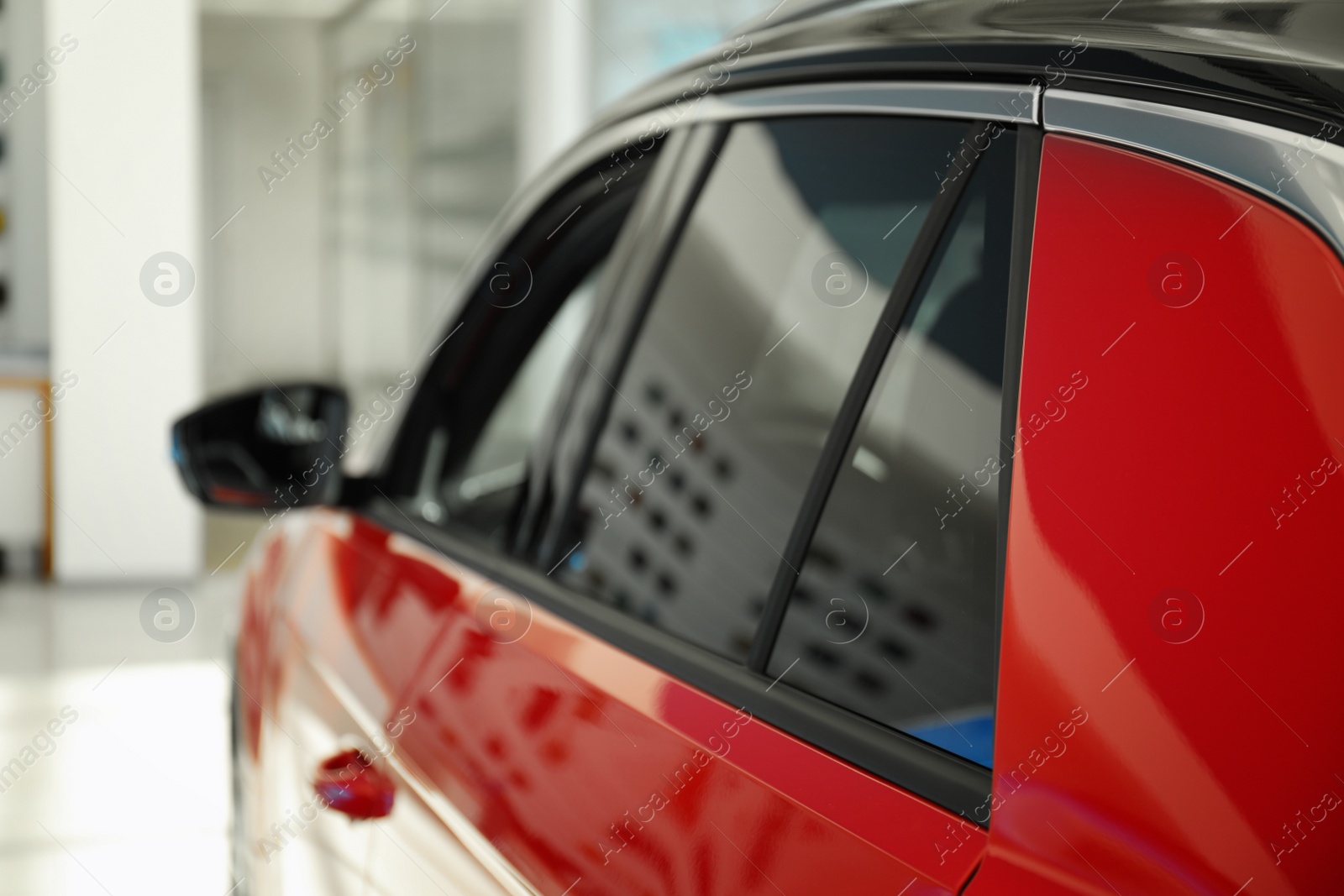 Photo of Modern car with tinting foil on window, closeup