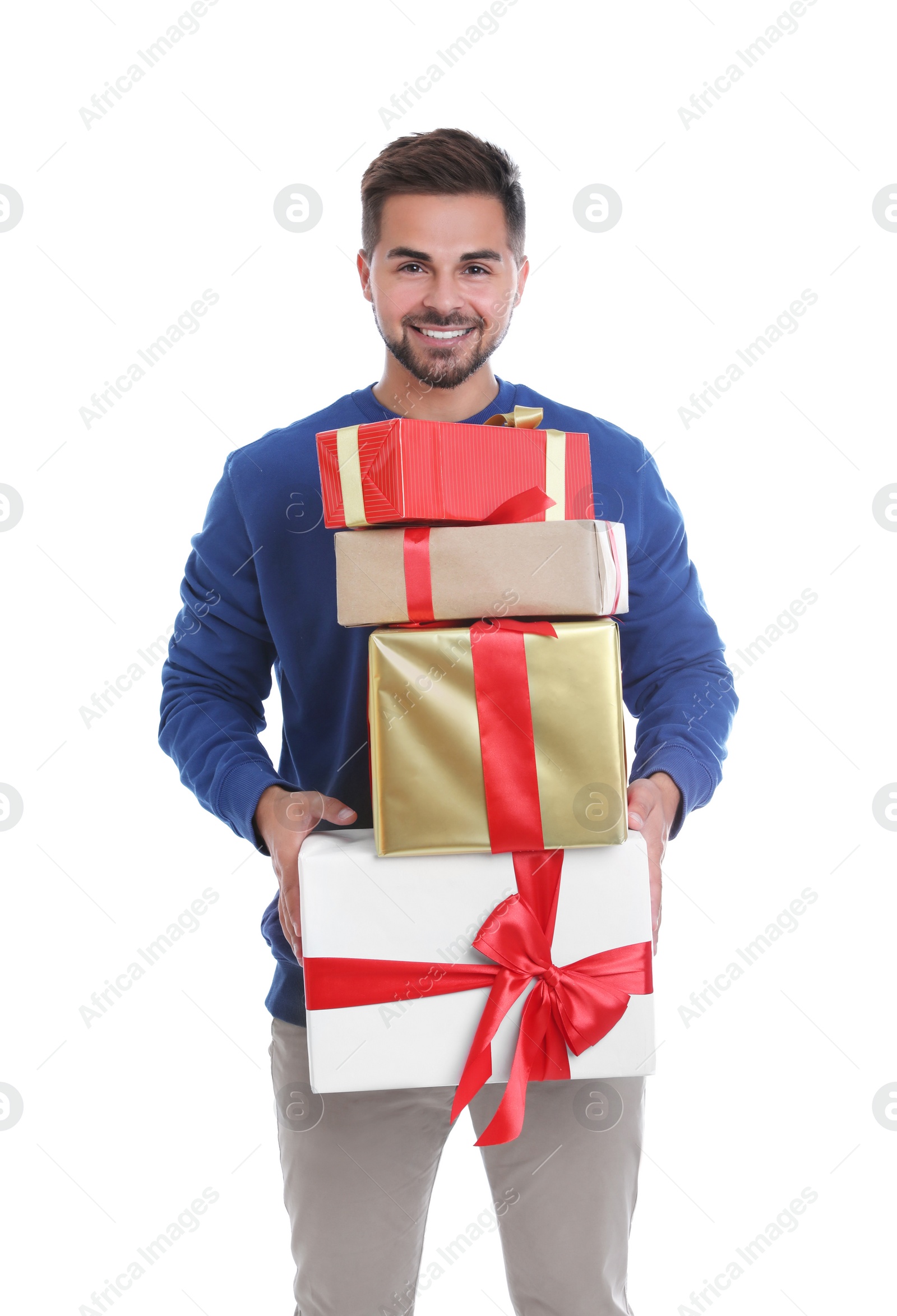 Photo of Happy young man holding Christmas gifts on white background