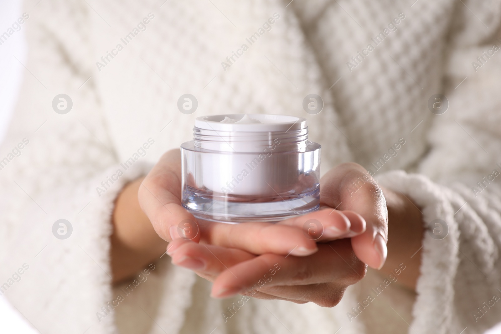 Photo of Woman with jar of moisturizing cream, closeup