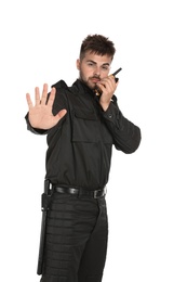 Male security guard in uniform using portable radio transmitter on white background