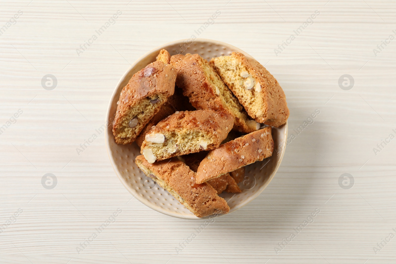 Photo of Traditional Italian almond biscuits (Cantucci) on white wooden table, top view