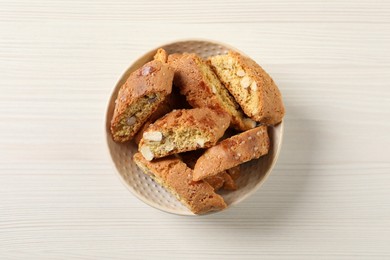 Traditional Italian almond biscuits (Cantucci) on white wooden table, top view
