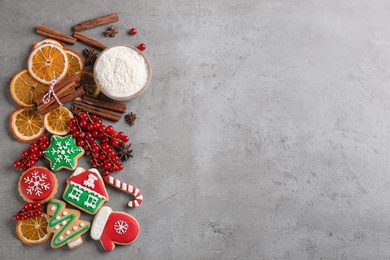 Photo of Flat lay composition with homemade Christmas cookies on grey table. Space for text