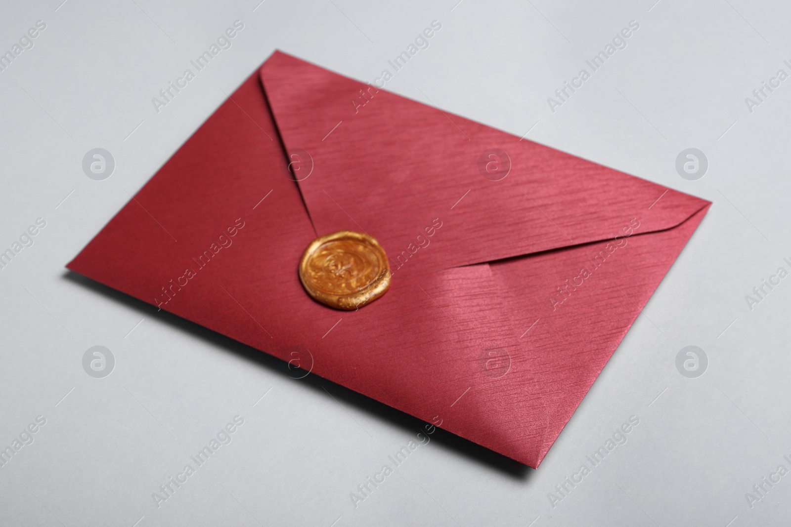 Photo of Red envelope with wax seal on grey background