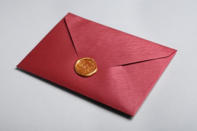 Photo of Red envelope with wax seal on grey background