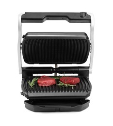 Electric grill with raw meat steaks and rosemary isolated on white