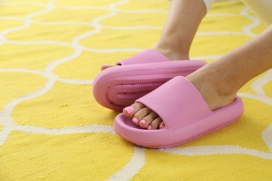 Photo of Woman in pink slippers indoors, closeup view