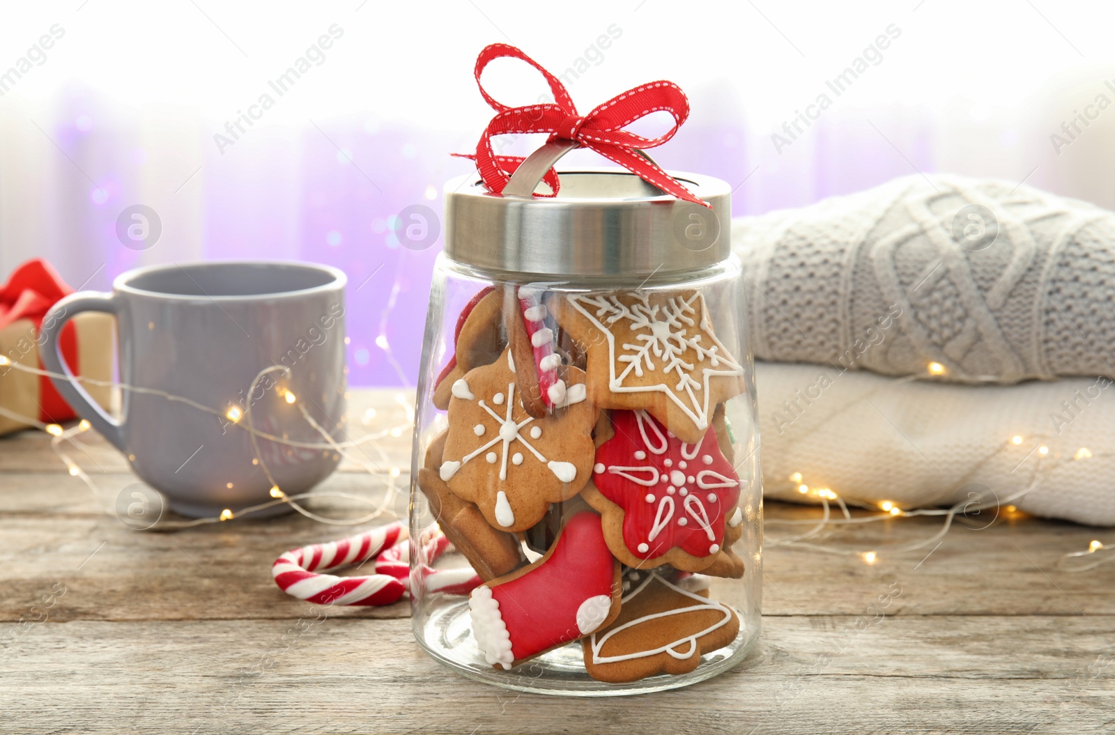 Photo of Glass jar with tasty homemade Christmas cookies on table