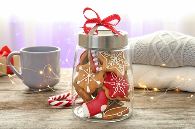 Glass jar with tasty homemade Christmas cookies on table