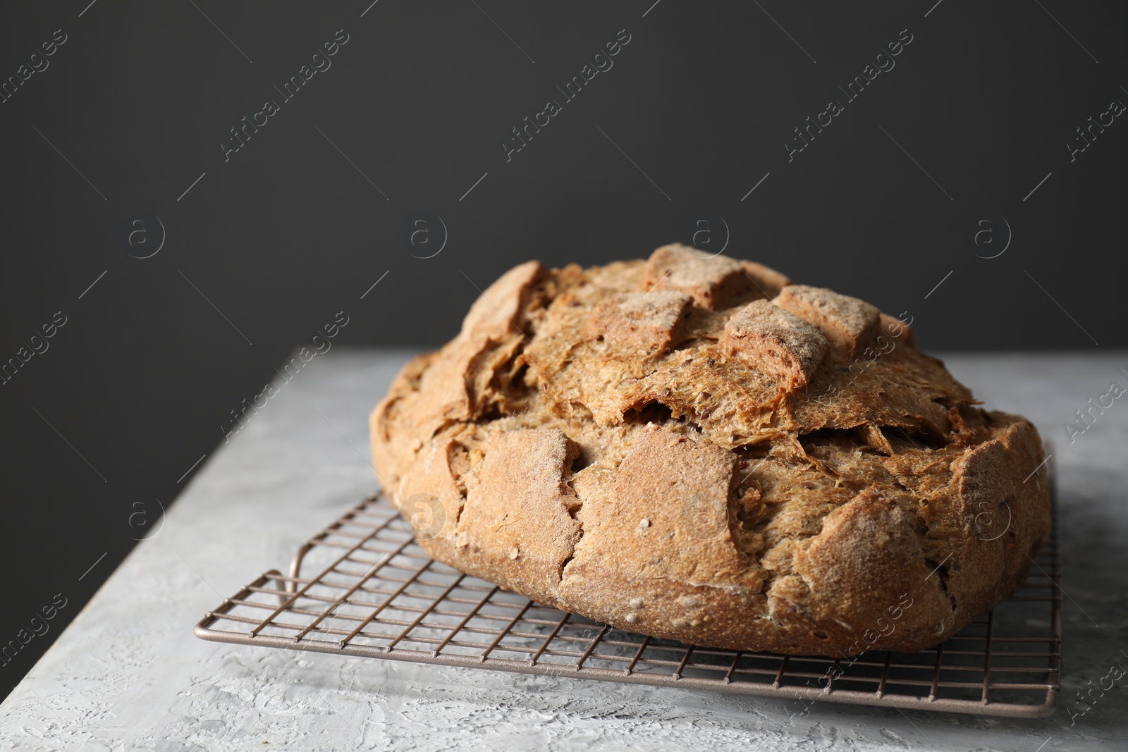 Photo of Freshly baked sourdough bread on grey table, closeup