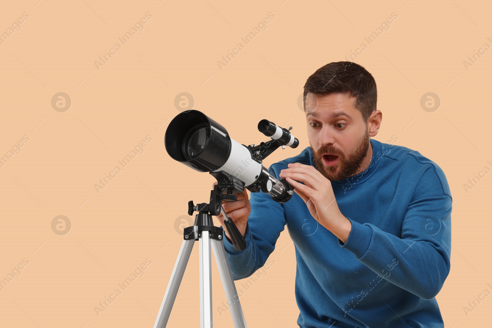 Photo of Excited astronomer with telescope on beige background. Space for text