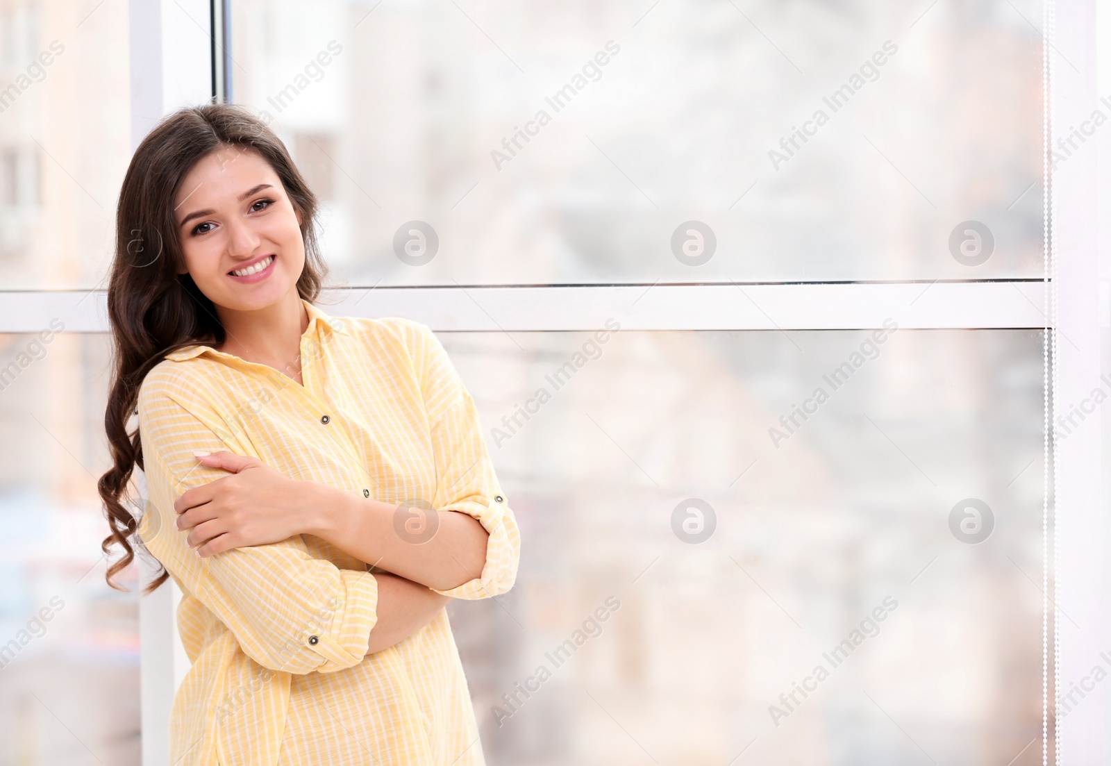 Photo of Beautiful young woman near window at home