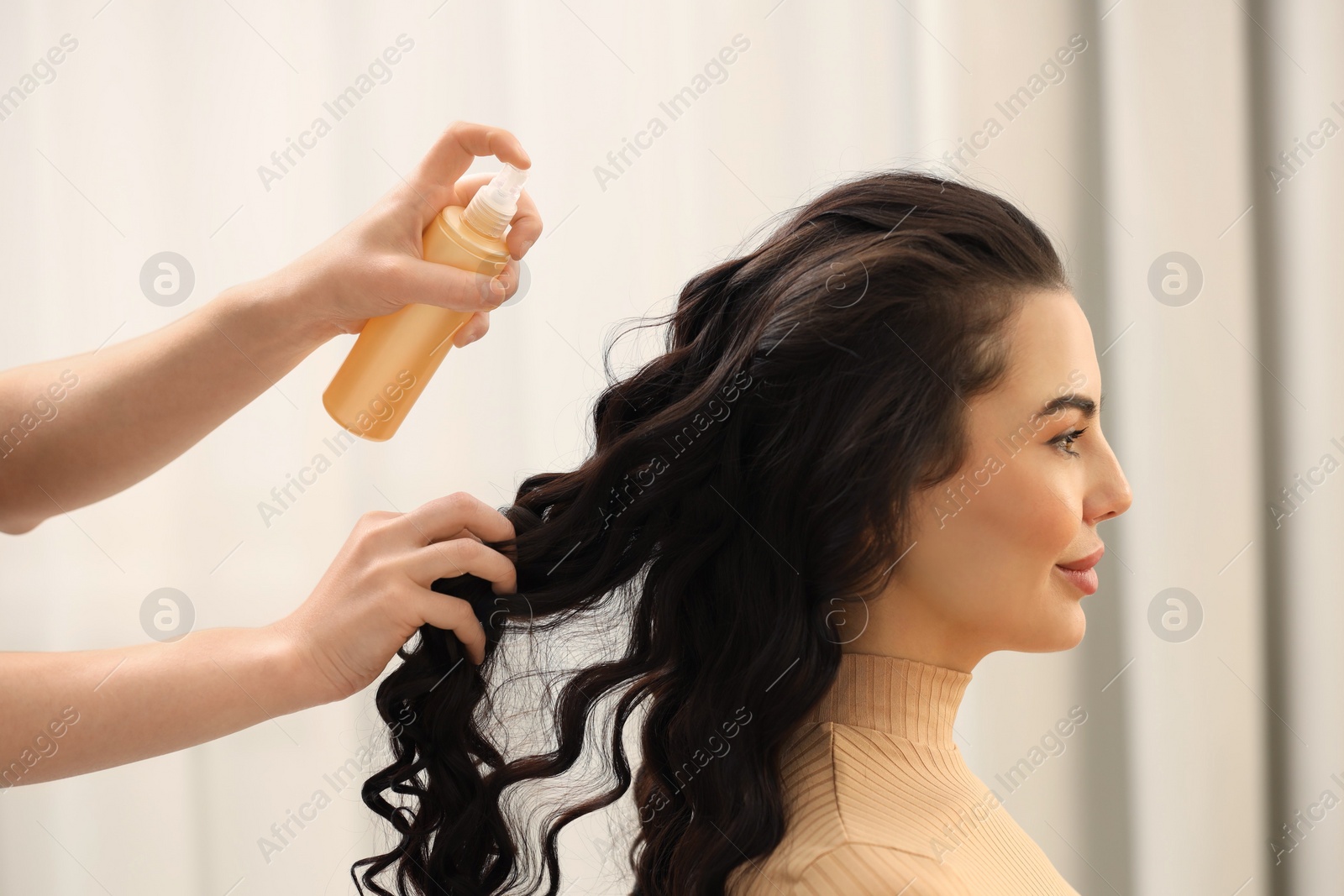 Photo of Hair styling. Professional hairdresser working with client indoors, closeup