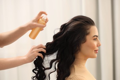 Hair styling. Professional hairdresser working with client indoors, closeup