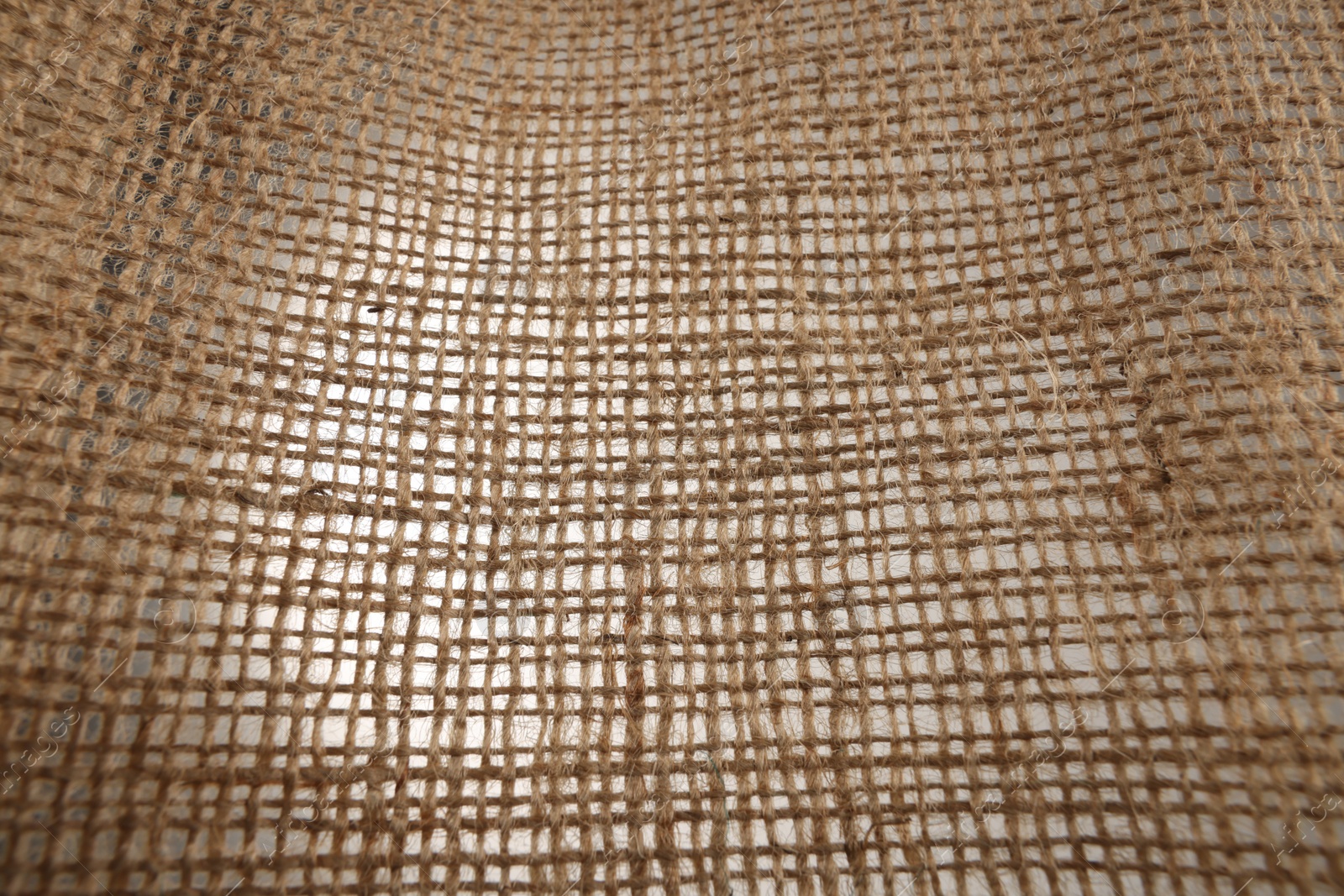 Photo of Texture of natural burlap fabric as background, closeup