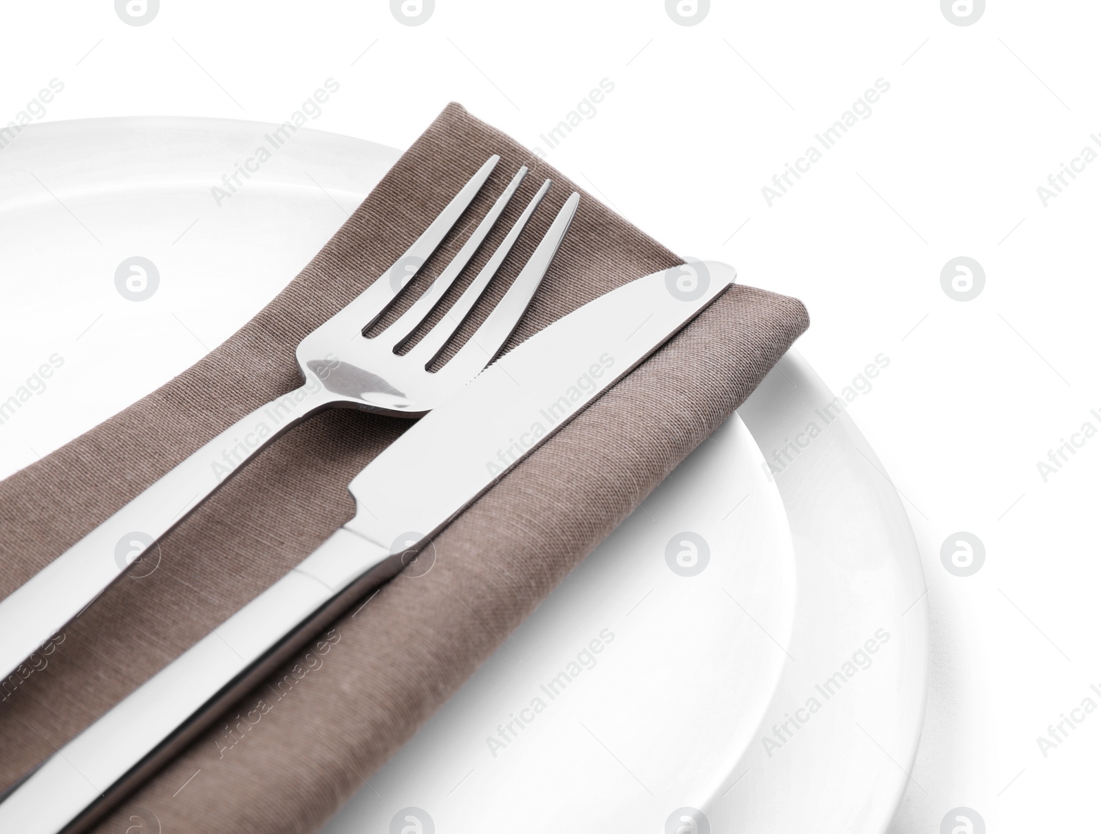 Photo of Plates with clean cutlery and napkin isolated on white