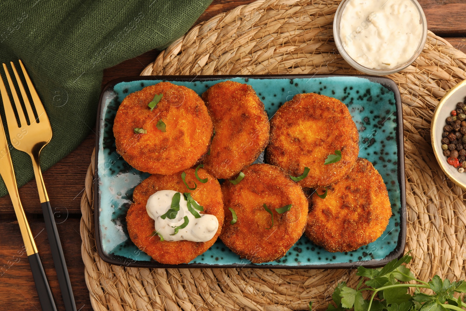 Photo of Tasty vegan cutlets served with sauce on wooden table, flat lay