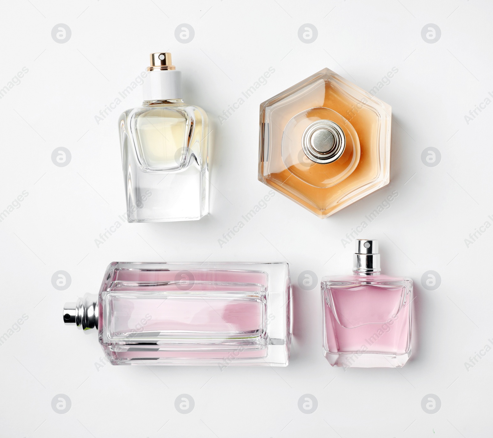 Photo of Transparent bottles of perfume on white background