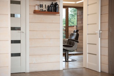 Photo of Stylish barbershop interior with professional hairdresser's workplace