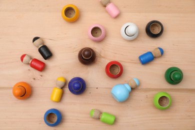 Wooden colorful dolls shaped building blocks on table, flat lay. Montessori toy