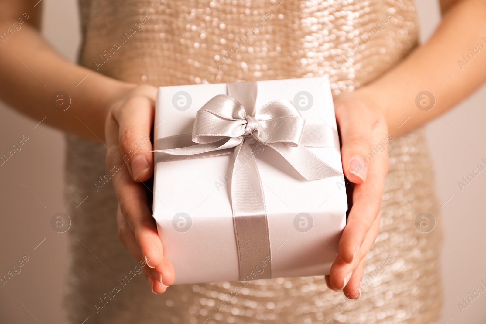 Photo of Woman holding beautiful gift box, closeup