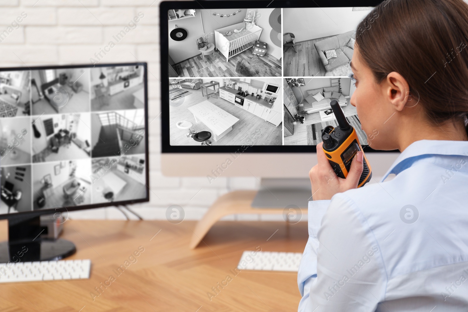 Photo of Female security guard with portable transmitter at workplace