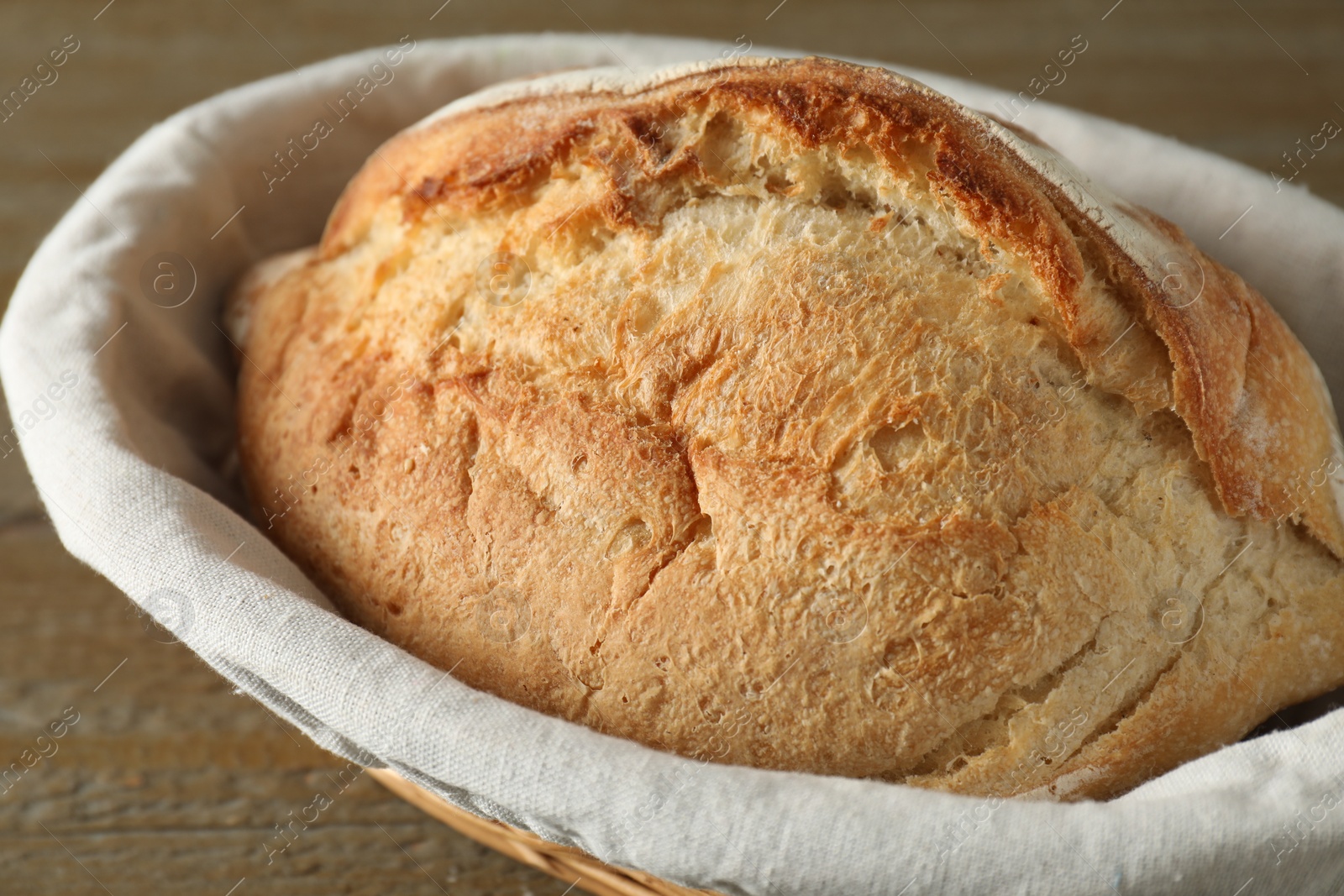 Photo of Basket with fresh bread on table, closeup