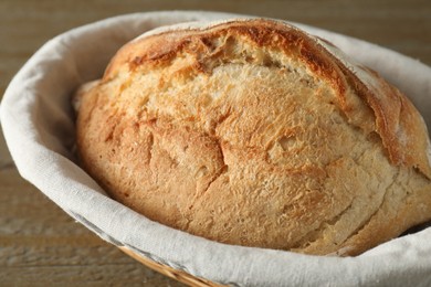 Photo of Basket with fresh bread on table, closeup