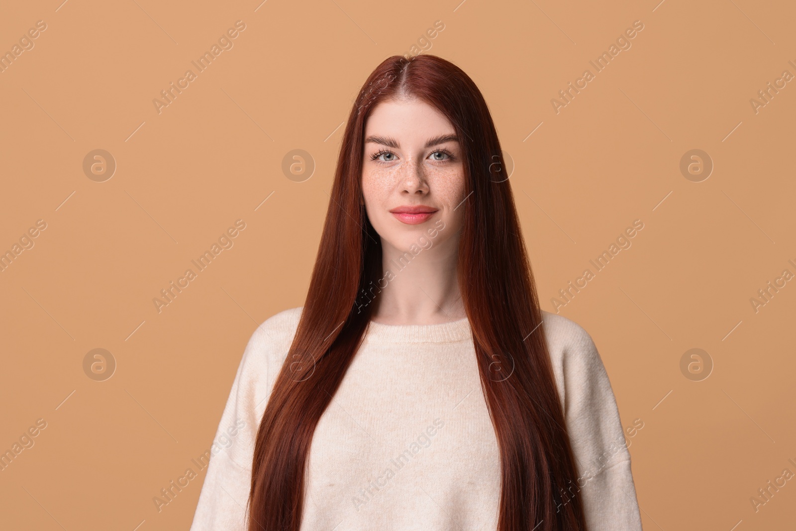 Photo of Portrait of beautiful woman on beige background