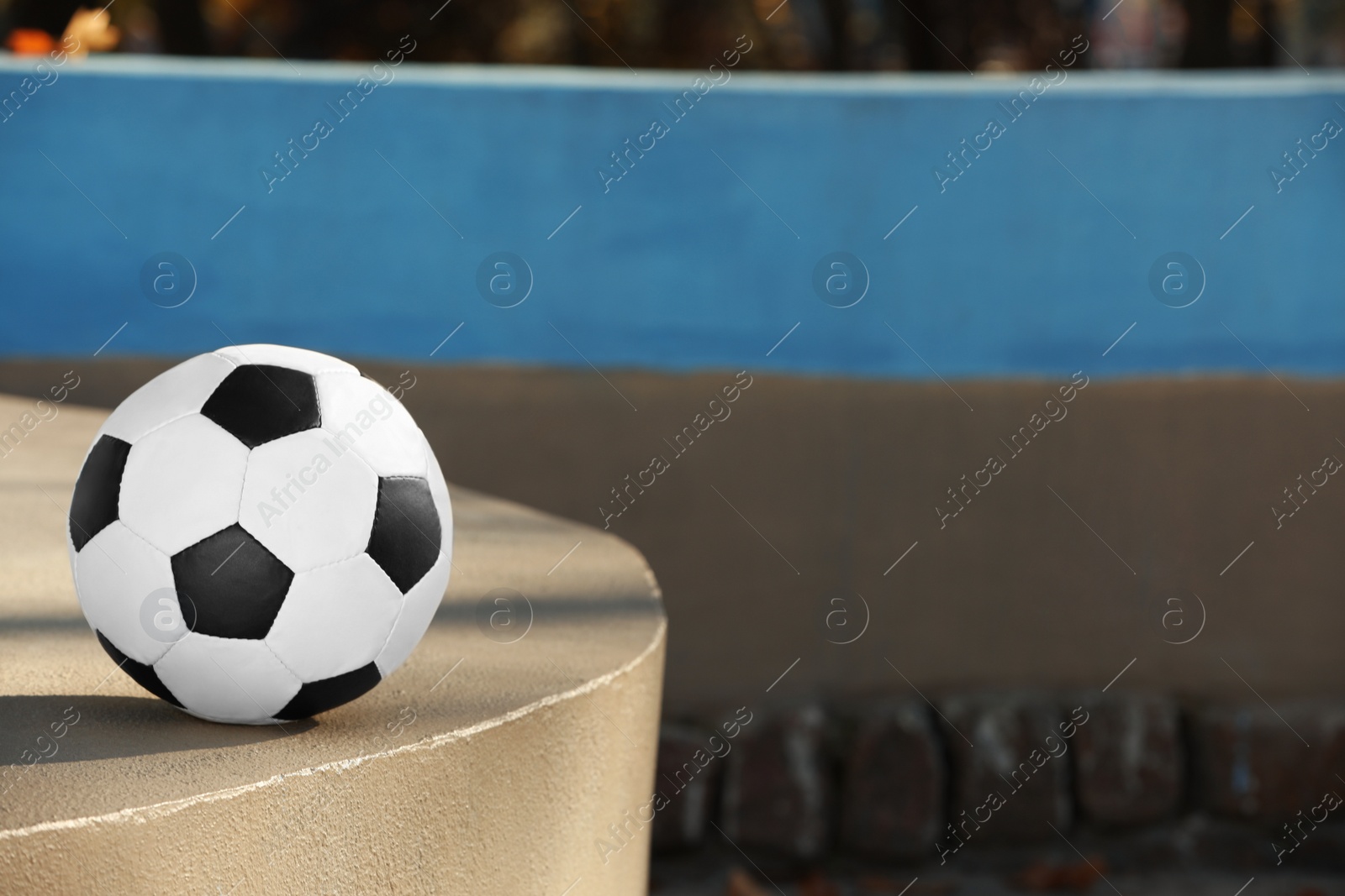 Photo of Soccer ball outdoors on sunny day, space for text