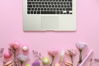 Flat lay composition with laptop on pink background. Beauty blogger's workplace