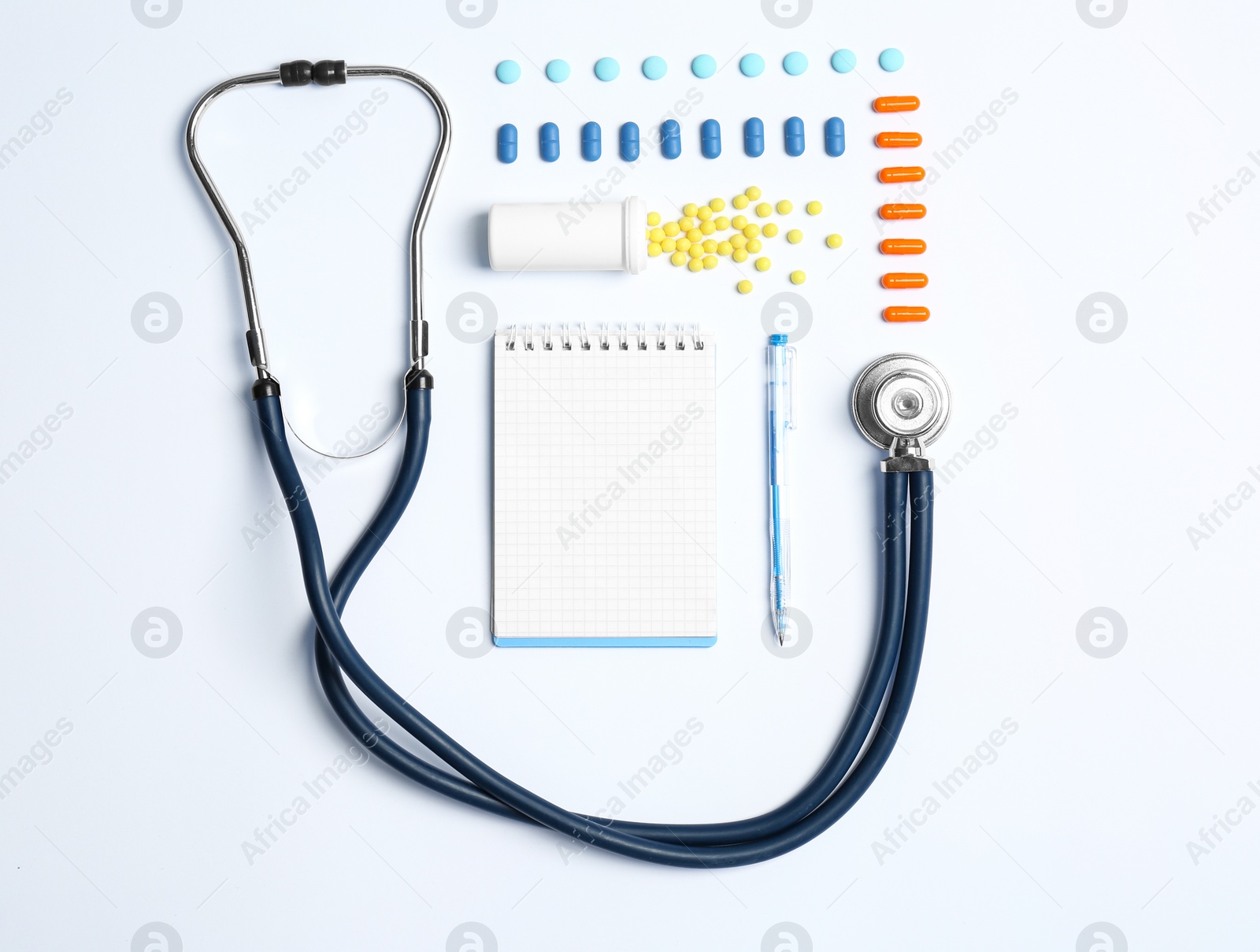 Photo of Flat lay composition with medical equipment and pills on light background