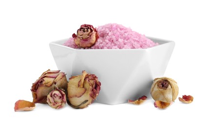 Bowl of pink sea salt and dry rose flowers isolated on white