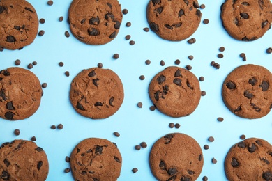 Delicious chocolate chip cookies on color background, flat lay