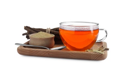 Photo of Aromatic licorice tea in cup, dried sticks of licorice root, powder and spoon on white background