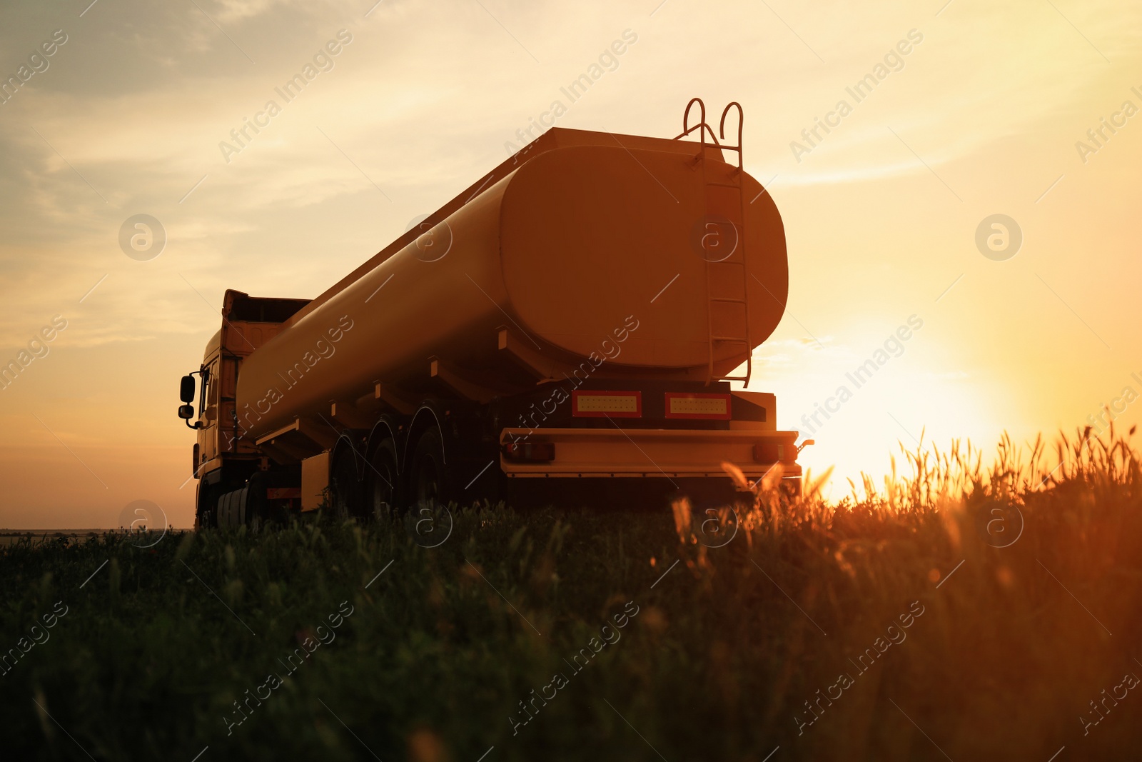 Photo of Modern yellow truck parked on country road