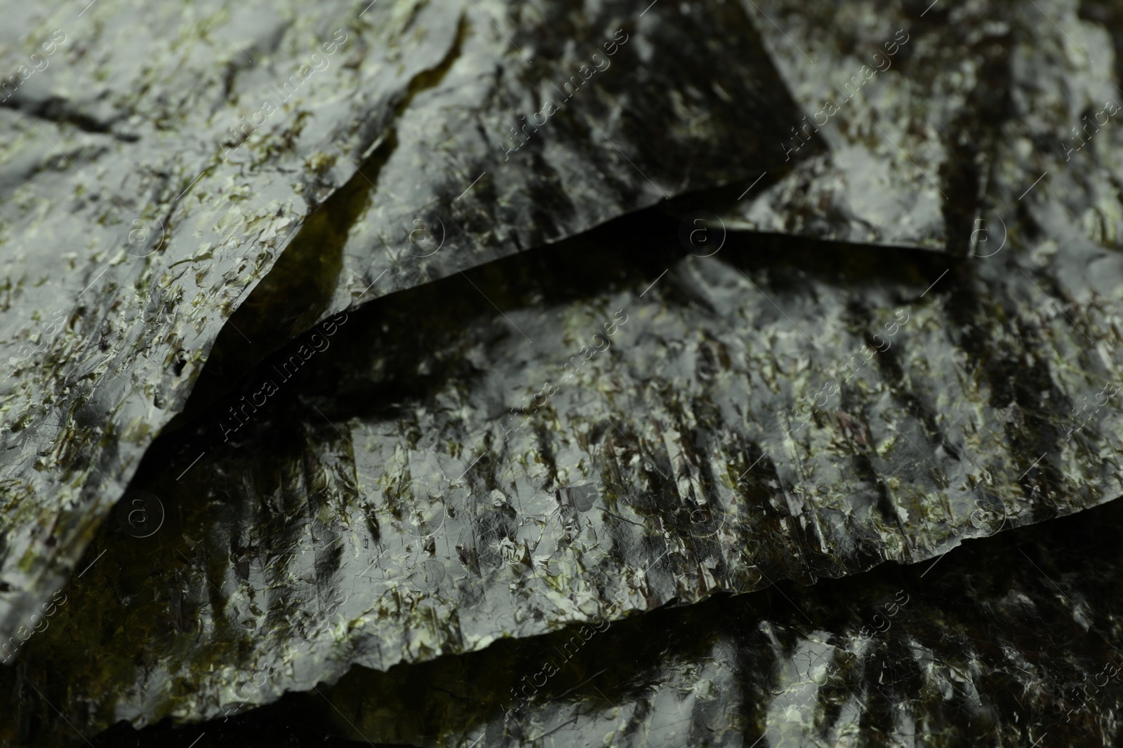 Photo of Dry nori sheets as background, closeup view