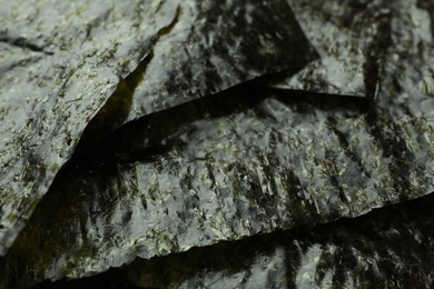 Dry nori sheets as background, closeup view