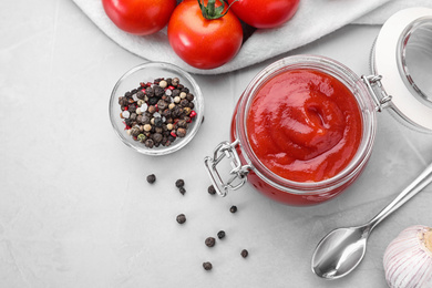 Flat lay composition with tomato sauce on light grey table