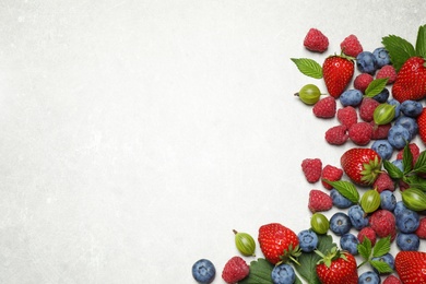 Photo of Mix of fresh berries on light table, flat lay. Space for text