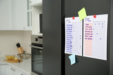 Photo of To do lists and sticky notes on fridge in kitchen. Space for text