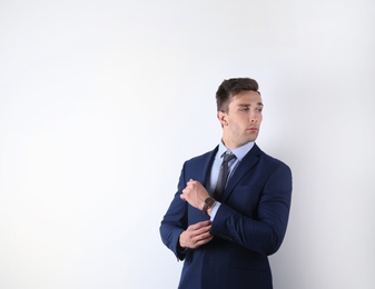 Photo of Handsome young man in suit on white background